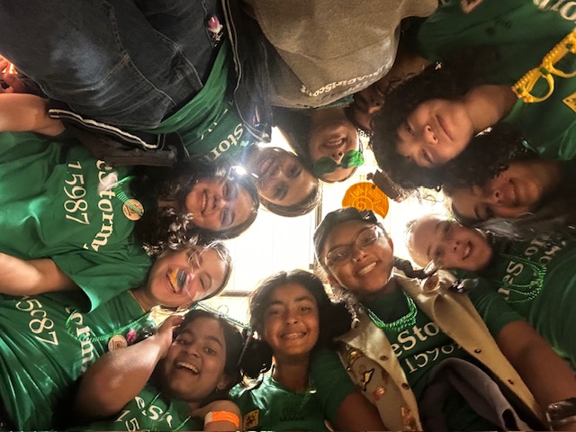 two girls working on building a robot at a table