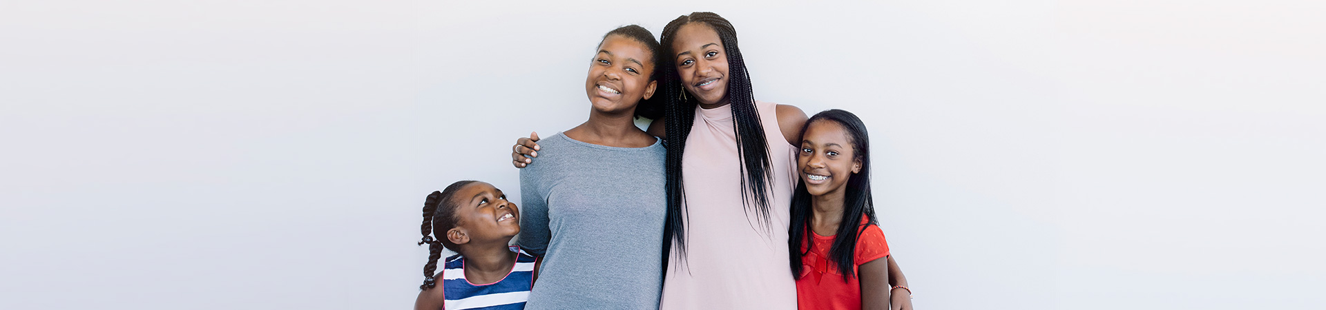  four girls of various ages smiling at camera 